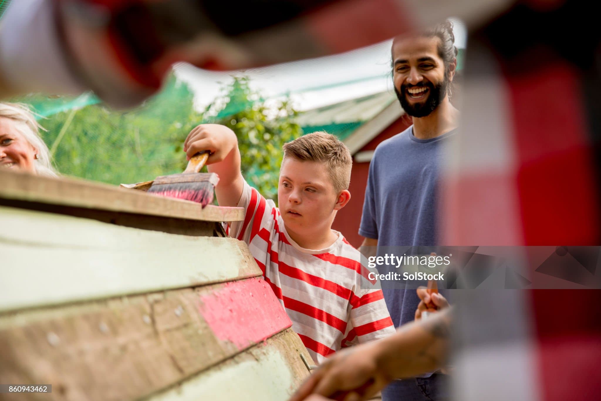 A child helps paint at the farm